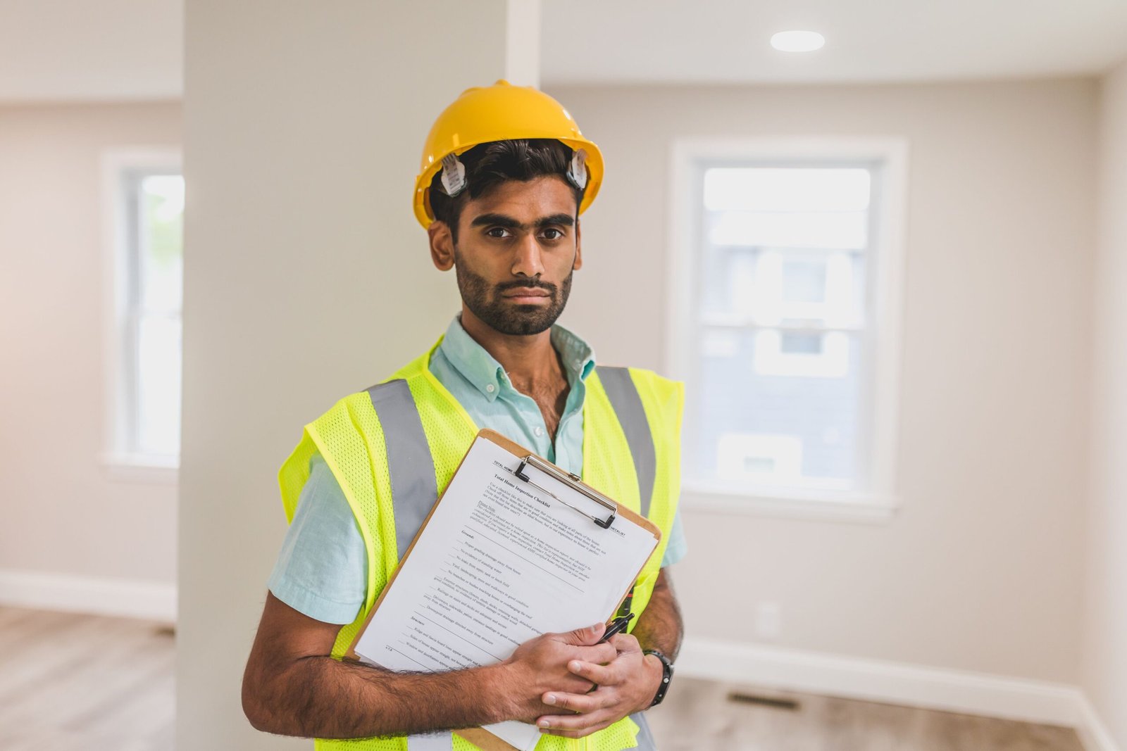 Structural engineer reviewing blueprints during a foundation inspection